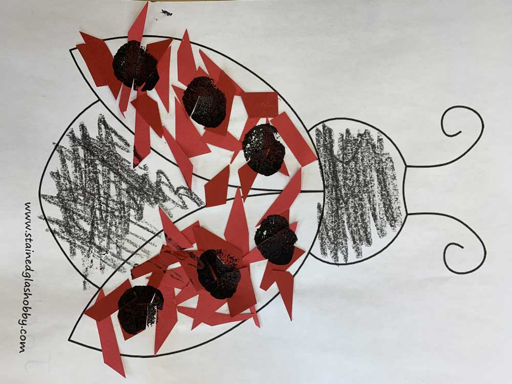 A drawing of a ladybug with red leaves on it.